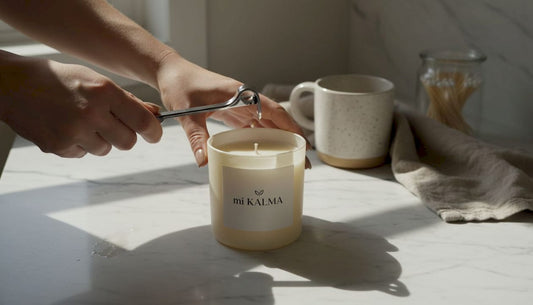 Hands trimming candle wick with trimmers